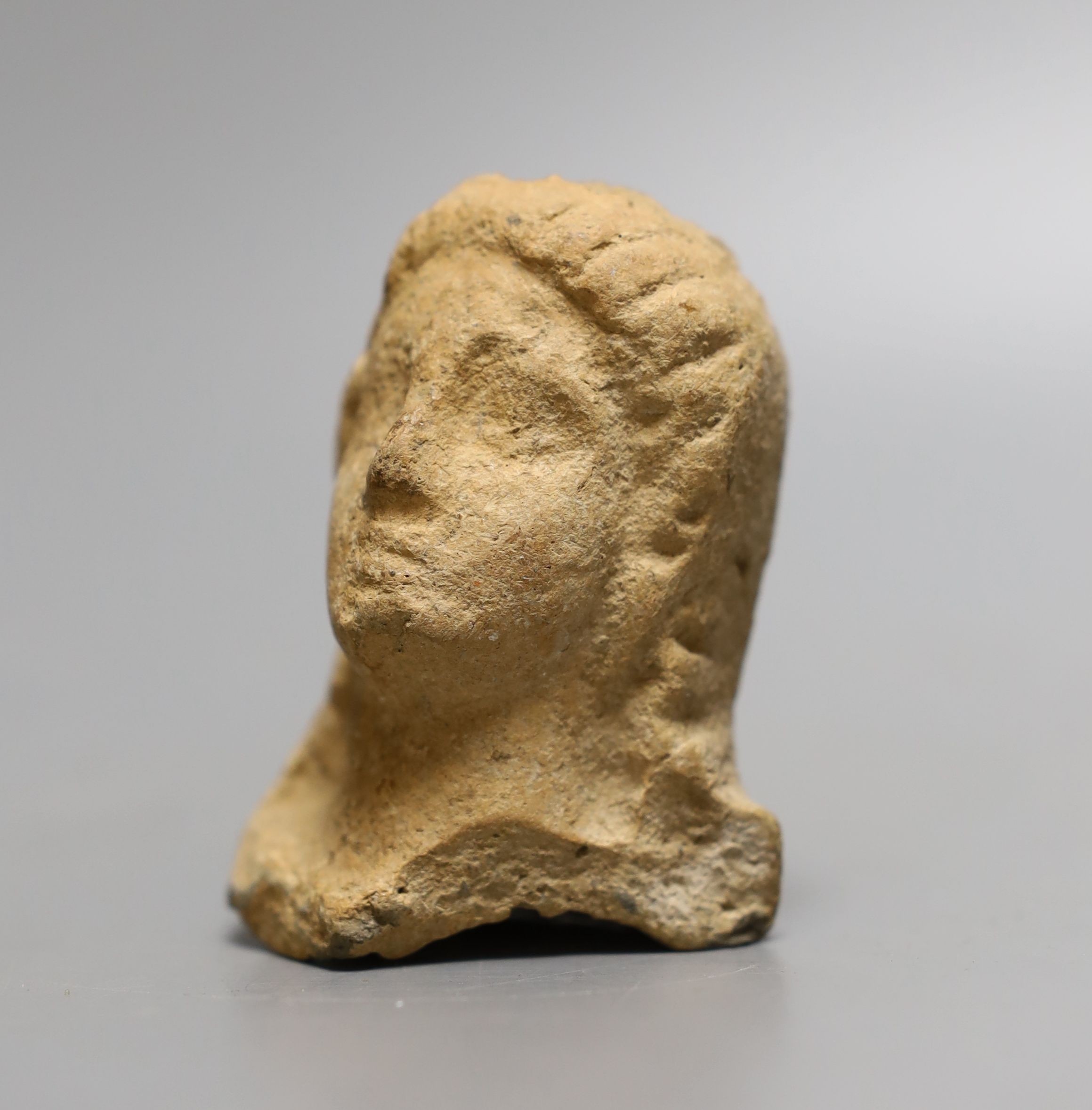 An antiquity terracotta figure head, 8cms high.